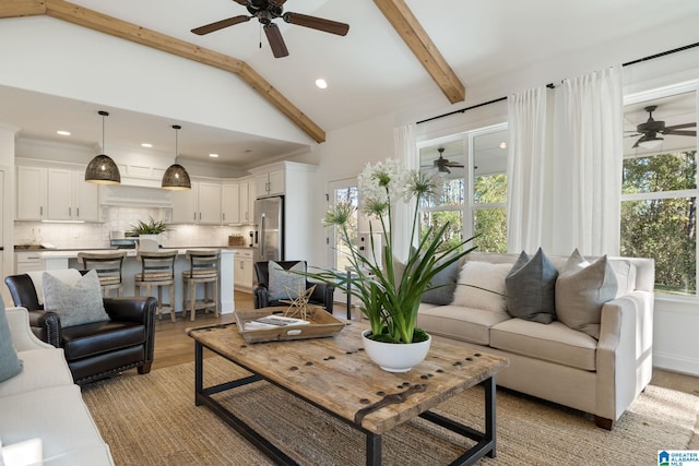 living room with beam ceiling, light wood-type flooring, and high vaulted ceiling