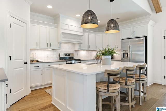 kitchen with white cabinetry, light hardwood / wood-style flooring, and stainless steel appliances