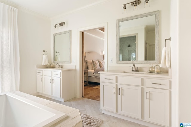 bathroom with hardwood / wood-style floors, vanity, ornamental molding, and a washtub