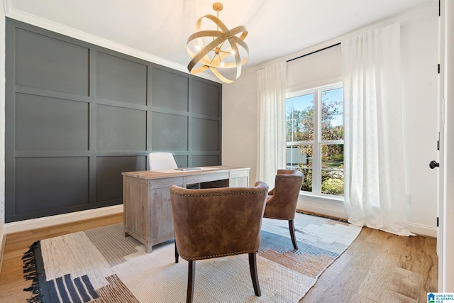 home office with crown molding, a notable chandelier, and light wood-type flooring