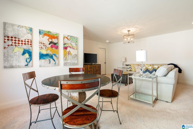 carpeted dining room with an inviting chandelier