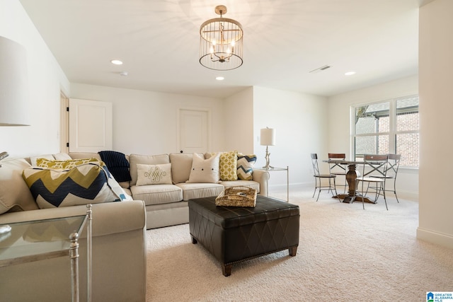 living room with light carpet and a chandelier