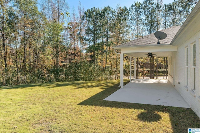 view of yard with ceiling fan and a patio area