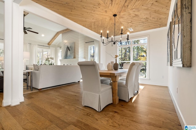 dining room featuring wood-type flooring, ceiling fan with notable chandelier, ornamental molding, and wood ceiling