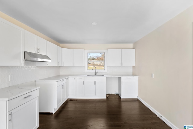 kitchen with white cabinets, dark hardwood / wood-style floors, sink, and tasteful backsplash