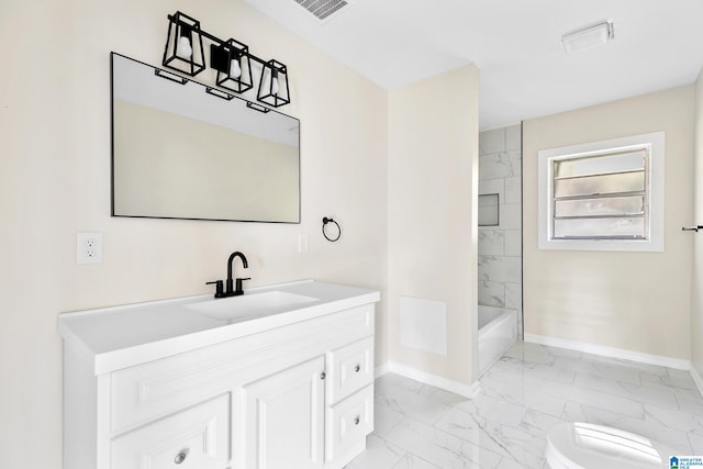 full bathroom featuring vanity, tiled shower / bath combo, and toilet