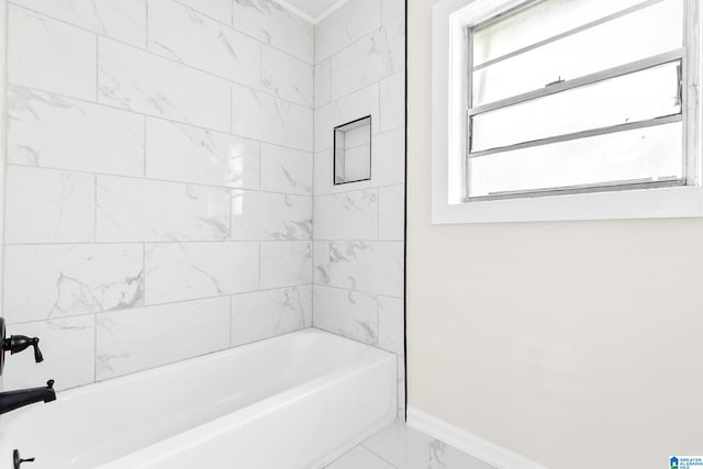 bathroom featuring plenty of natural light and tiled shower / bath combo