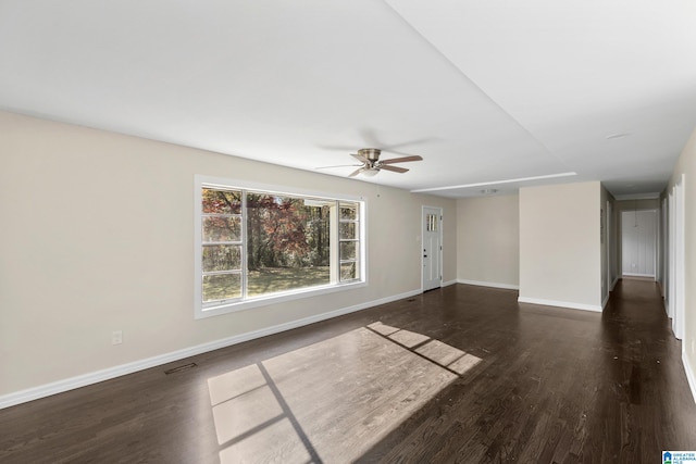 spare room featuring dark hardwood / wood-style floors and ceiling fan