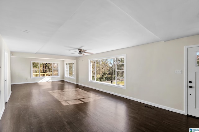 unfurnished living room with dark hardwood / wood-style floors and ceiling fan