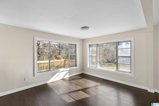 empty room with dark hardwood / wood-style floors