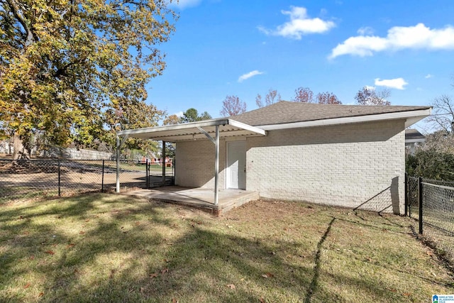 back of house featuring a lawn and a patio area