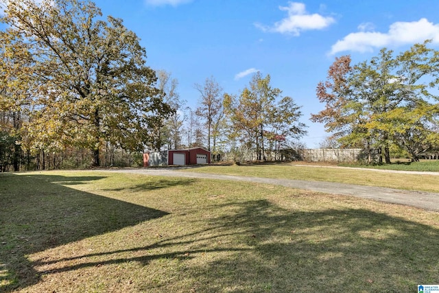 view of yard with a garage and an outdoor structure