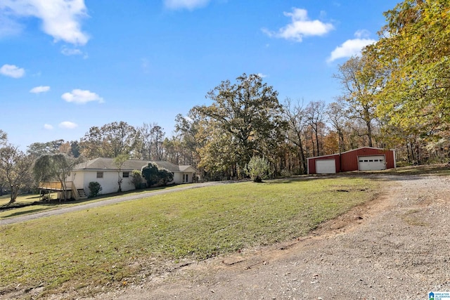 view of yard with a garage and an outdoor structure