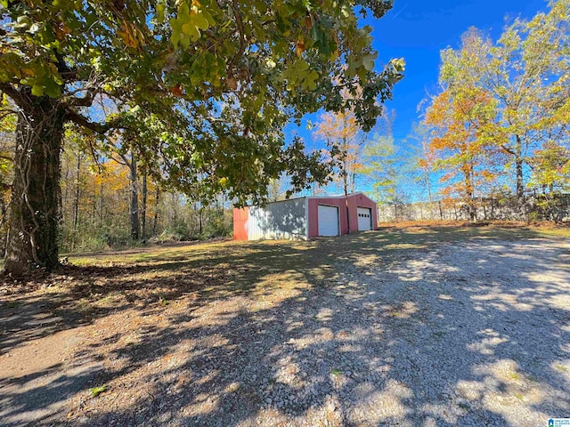 view of yard with an outbuilding and a garage