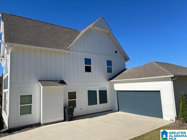 back of property featuring a garage