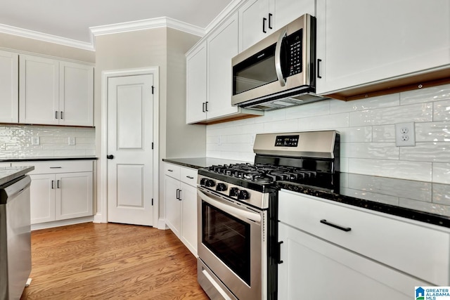 1114 Eagle Nest Cir, Birmingham, AL 35242 - kitchen with appliances with stainless steel finishes, ornamental molding, white cabinets, tasteful backsplash, and light wood-style flooring