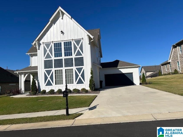 view of front of house featuring a garage and a front lawn