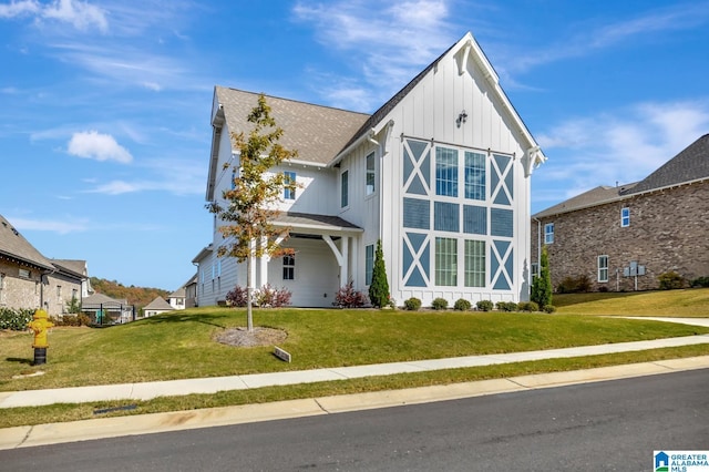 1114 Eagle Nest Cir, Birmingham, AL 35242 - view of front of home with board and batten siding, a front yard, and a shingled roof