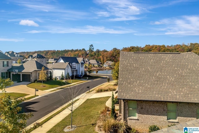 1114 Eagle Nest Cir, Birmingham, AL 35242 - view of asphalt street featuring a residential view, sidewalks, curbs, and a water view