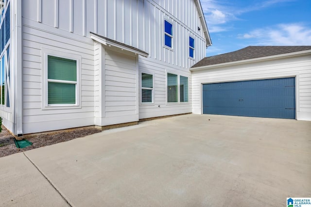 1114 Eagle Nest Cir, Birmingham, AL 35242 - view of side of home with board and batten siding, driveway, and an attached garage