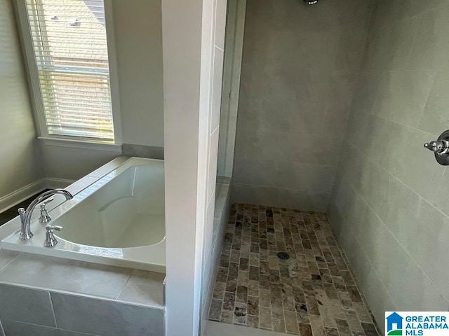 bathroom with separate shower and tub