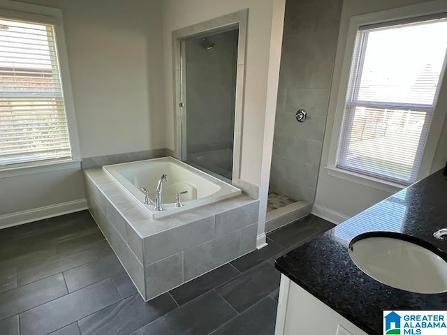 bathroom with vanity and independent shower and bath