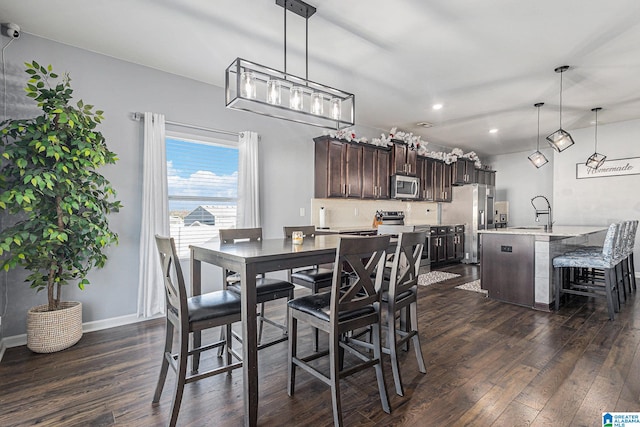 dining room with sink and dark hardwood / wood-style floors