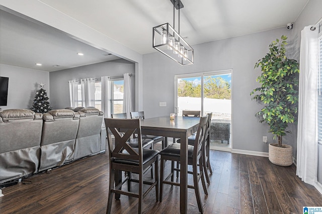 dining space featuring a notable chandelier and dark hardwood / wood-style flooring