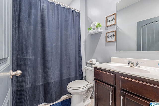 bathroom with vanity, toilet, and walk in shower