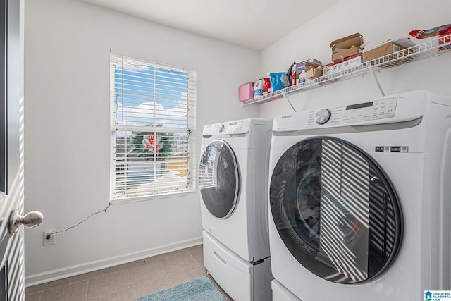 clothes washing area with independent washer and dryer and light tile patterned floors