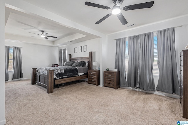 carpeted bedroom featuring ceiling fan and multiple windows