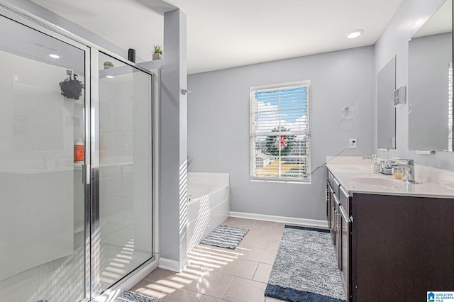 bathroom with tile patterned flooring, vanity, and separate shower and tub