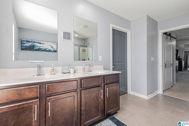 bathroom featuring vanity, tile patterned floors, and a shower with shower door