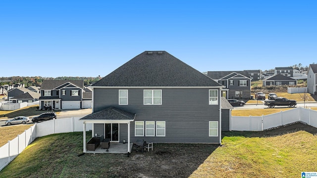 back of property featuring a yard and a patio