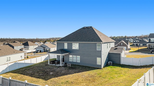 rear view of property with a lawn and central AC