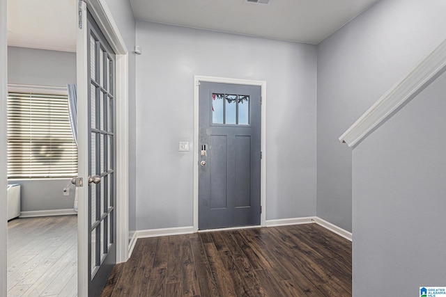 entryway featuring dark hardwood / wood-style floors and french doors