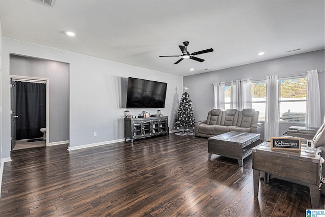 living room featuring dark hardwood / wood-style floors and ceiling fan