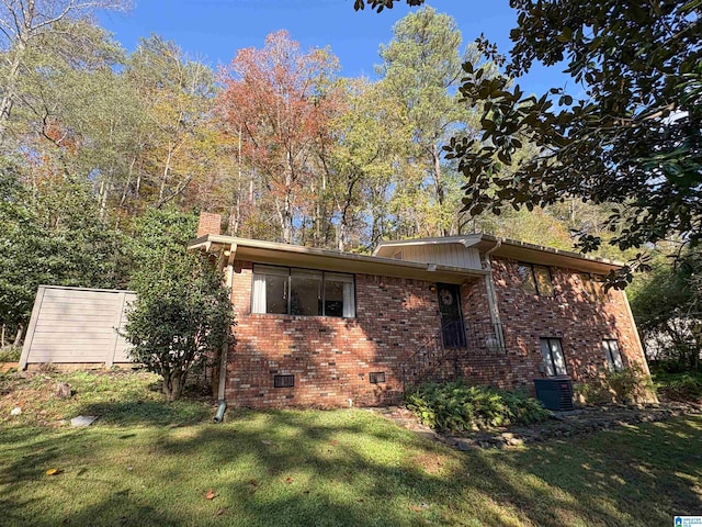 view of side of property with a lawn