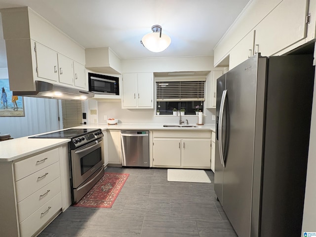 kitchen featuring stainless steel appliances, white cabinetry, and sink