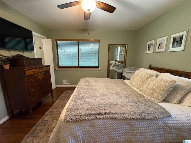 bedroom with dark hardwood / wood-style flooring and ceiling fan