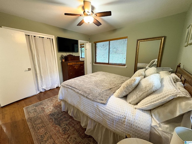 bedroom with ceiling fan and dark wood-type flooring