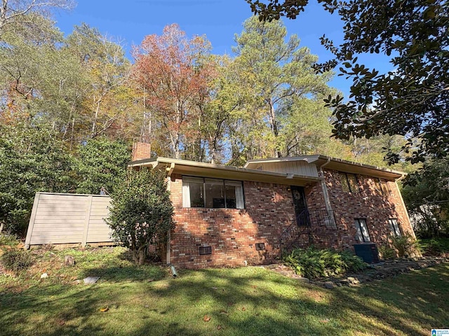 view of home's exterior with a yard