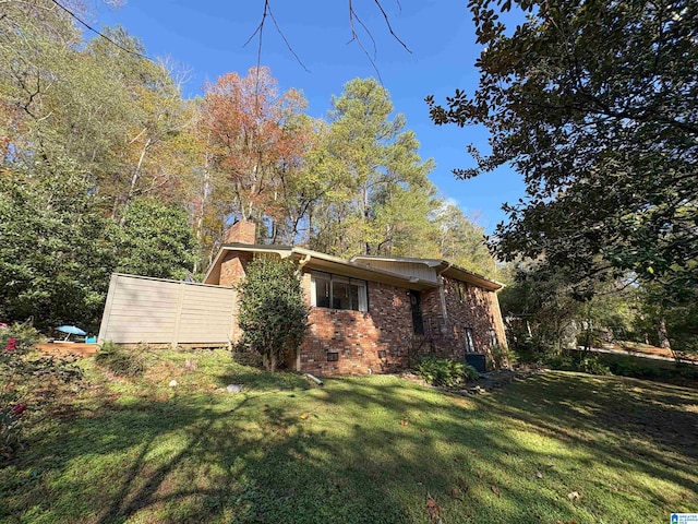 view of side of home with a lawn