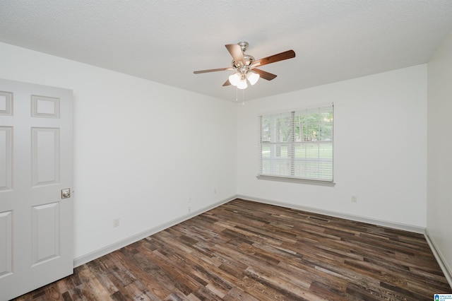 spare room featuring a textured ceiling, ceiling fan, and dark wood-type flooring