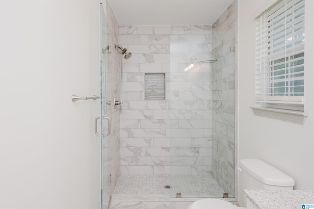 bathroom with toilet and an enclosed shower