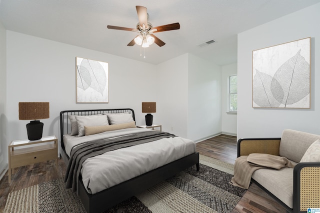 bedroom with ceiling fan and dark wood-type flooring