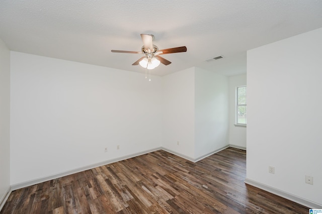 unfurnished room with a textured ceiling, dark hardwood / wood-style flooring, and ceiling fan