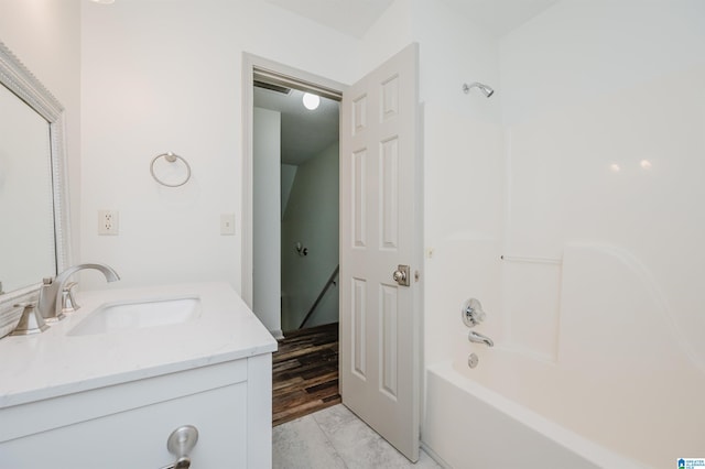 bathroom with shower / tub combination, hardwood / wood-style floors, and vanity