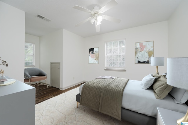 bedroom with ceiling fan and dark hardwood / wood-style floors