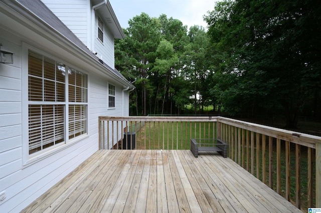 wooden terrace with a lawn